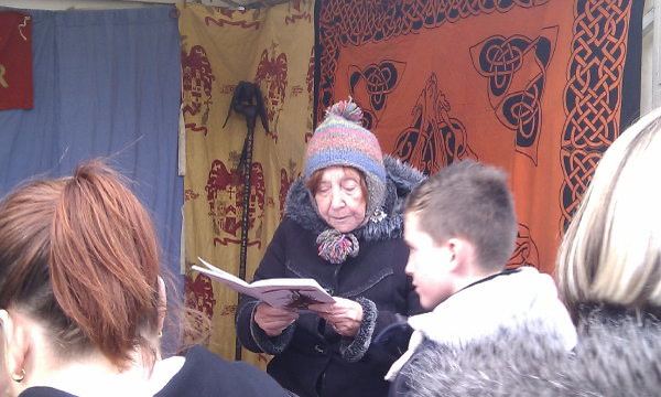 Mary Gonzalez reading to an audience at a Vikings Day event